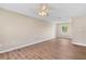 Bright, airy living room with modern wood-look flooring, ceiling fan, fresh paint and natural light at 4 Kristin Ln, Eustis, FL 32726