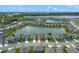 Aerial view showcasing the property's location, community lake, and neighborhood layout at 424 Noble Ave, Davenport, FL 33837