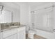 Bright bathroom featuring a vanity with granite counters and a shower-tub combo at 424 Noble Ave, Davenport, FL 33837