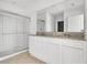 Bright bathroom featuring a double vanity with granite counters and a glass enclosed shower at 424 Noble Ave, Davenport, FL 33837