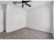 Bedroom featuring neutral carpet, a ceiling fan, and two doors at 424 Noble Ave, Davenport, FL 33837