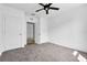Bedroom featuring neutral carpet, a ceiling fan, and two doors at 424 Noble Ave, Davenport, FL 33837