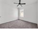 Bedroom featuring neutral carpet, a ceiling fan, and window to the outside at 424 Noble Ave, Davenport, FL 33837