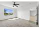 Bright bedroom featuring carpet flooring, a ceiling fan, and a large window overlooking the water at 424 Noble Ave, Davenport, FL 33837