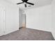 Bedroom featuring neutral carpet, a ceiling fan, and two doors at 424 Noble Ave, Davenport, FL 33837