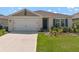 Charming single-story home with a two-car garage and well-maintained landscaping at 424 Noble Ave, Davenport, FL 33837