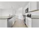 A kitchen featuring white cabinetry, stainless steel appliances, and granite countertops at 424 Noble Ave, Davenport, FL 33837