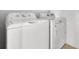 White GE washer and Maytag dryer in the laundry room at 424 Noble Ave, Davenport, FL 33837