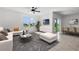 Bright living room with modern furnishings and a large window overlooking the lake at 424 Noble Ave, Davenport, FL 33837
