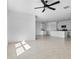 Open-concept living space with tile flooring and an adjacent kitchen area at 424 Noble Ave, Davenport, FL 33837
