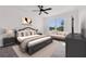 Cozy main bedroom with a luxurious bed, sofa, and a beautiful view from the window at 424 Noble Ave, Davenport, FL 33837