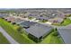 An aerial view highlights the home's location with a manicured yard, next to a community walking path at 4346 Pezzullo Cir, The Villages, FL 32163