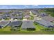 Aerial view displays a beautiful home with a view of the neighborhood and a glimpse of a pond at 4346 Pezzullo Cir, The Villages, FL 32163
