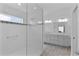 Bright bathroom features dual sinks, a glass-enclosed shower, and stylish fixtures at 4346 Pezzullo Cir, The Villages, FL 32163