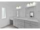 Well-lit bathroom featuring dual sinks, quartz countertops, modern lighting, and a vanity area at 4346 Pezzullo Cir, The Villages, FL 32163