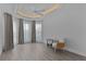 Bright bedroom features elegant tray ceiling with recessed lighting and light wood floors at 4346 Pezzullo Cir, The Villages, FL 32163