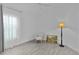 This bedroom offers wood floors, floor lamp, and large picture window at 4346 Pezzullo Cir, The Villages, FL 32163