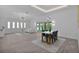 Bright dining area with modern table set, stylish light fixture, and sliding glass doors at 4346 Pezzullo Cir, The Villages, FL 32163