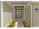 Front entrance featuring double glass doors, manicured landscaping, and a welcoming path at 4346 Pezzullo Cir, The Villages, FL 32163