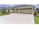 Beautiful single-story home featuring a two-car garage and a well-maintained concrete driveway at 4346 Pezzullo Cir, The Villages, FL 32163