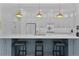 Contemporary kitchen featuring a spacious island with bar stools, modern appliances, and stylish pendant lights at 4346 Pezzullo Cir, The Villages, FL 32163