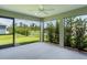 Screened lanai features concrete floor with backyard view and ceiling fan at 4346 Pezzullo Cir, The Villages, FL 32163