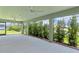 Covered lanai offers privacy landscaping and a concrete floor with ceiling fans at 4346 Pezzullo Cir, The Villages, FL 32163