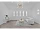 Inviting living area with a modern sofa, bright windows, and stylish lighting at 4346 Pezzullo Cir, The Villages, FL 32163