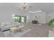 Bright living room featuring modern lighting, sliding glass doors, and an adjacent dining area at 4346 Pezzullo Cir, The Villages, FL 32163