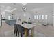 Bright and open living space showcasing dining, living, and kitchen areas with stylish fixtures at 4346 Pezzullo Cir, The Villages, FL 32163