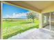 Covered patio overlooking a spacious backyard with a lake view at 439 Gentle Breeze Dr, Minneola, FL 34715