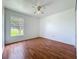 Bedroom featuring wood floors and a view of the backyard at 439 Gentle Breeze Dr, Minneola, FL 34715