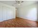 Bedroom featuring wood floors and a double closet at 439 Gentle Breeze Dr, Minneola, FL 34715