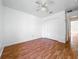 Cozy bedroom with wood floors, a ceiling fan, and ample closet space at 439 Gentle Breeze Dr, Minneola, FL 34715