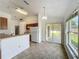 Cozy dining area featuring a sliding glass door, a window, and direct access to the kitchen for easy serving at 439 Gentle Breeze Dr, Minneola, FL 34715