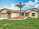 Inviting single-Gathering home with a lush green lawn, a tidy mulch bed, and a convenient two-car garage at 439 Gentle Breeze Dr, Minneola, FL 34715