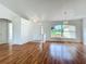 Bright living room with hardwood floors, a large window, and neutral walls, perfect for comfortable living at 439 Gentle Breeze Dr, Minneola, FL 34715