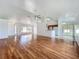 Open-concept living area with hardwood floors, connecting seamlessly to the kitchen and dining spaces at 439 Gentle Breeze Dr, Minneola, FL 34715