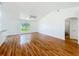 Open living room with hardwood floors, a vaulted ceiling, and a large window, creating an inviting atmosphere at 439 Gentle Breeze Dr, Minneola, FL 34715