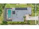 Aerial view of the property featuring a screened-in pool, lush landscaping, and a well-maintained roof at 5144 Rishley Run Way, Mount Dora, FL 32757