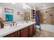 Bathroom with a double sink vanity, tile floors, and a shower-tub combination with tile surround at 5144 Rishley Run Way, Mount Dora, FL 32757