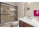 Bathroom with a glass-enclosed shower, and a wood vanity topped with white countertops at 5144 Rishley Run Way, Mount Dora, FL 32757