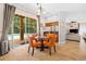 Cozy breakfast nook with glass table and orange chairs, and sliding door access to screened pool area at 5144 Rishley Run Way, Mount Dora, FL 32757