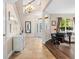 Inviting foyer with tile floors, grand staircase, chandelier and stylish decor at 5144 Rishley Run Way, Mount Dora, FL 32757