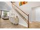 Bright foyer with staircase and decorative console table welcomes you into the home at 5144 Rishley Run Way, Mount Dora, FL 32757