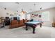 Game room with a pool table, media area with recliners, and a ceiling fan for added comfort at 5144 Rishley Run Way, Mount Dora, FL 32757