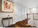 Upstairs hallway with wooden floors, white doors and trim, and staircase with white spindles at 5144 Rishley Run Way, Mount Dora, FL 32757