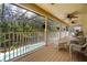 Screened lanai with wicker seating and a view of the pool and the lush backyard at 5144 Rishley Run Way, Mount Dora, FL 32757