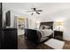 Bedroom with a dark wood bed frame, a ceiling fan, and a window offering natural light at 5144 Rishley Run Way, Mount Dora, FL 32757