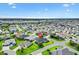 Aerial shot of a neighborhood featuring many homes and lush landscaping in a suburban location at 5868 Wood Stork Way, The Villages, FL 32163